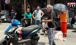 Kazada yaralanan genç kadına esnaftan şemsiyeli destek